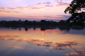 Obraz na płótnie Canvas Sunset reflected in the Okawango river, Caprivi Strip Namibia Africa