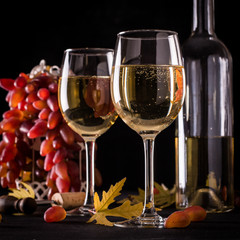 White wine still life in vintage style on black background