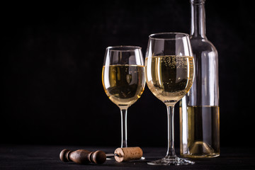 White wine still life in vintage style on black background