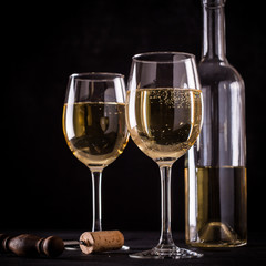 White wine still life in vintage style on black background