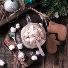 hot chocolate with marshmallows and cookies on black table, christmas concept
