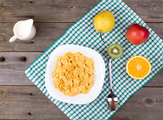 Breakfast: flakes in a plate, milk in a jug