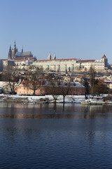 Snowy Prague gothic Castle above river Vltava in the sunny Day,  Czech Republic