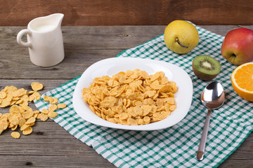 Breakfast: flakes in a plate, milk in a jug