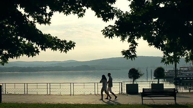 Two Young and Beautiful People Boy and Girl are Holding Hands. Italy August 2015 in Arona city