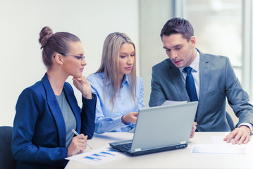 business team with laptop having discussion