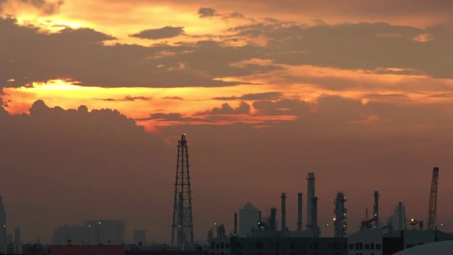  city downtown with oil refinery in twilight sky, time lapse