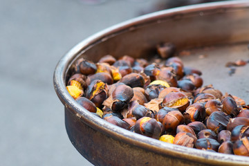 Grilled chestnuts for sale in a market stall