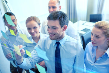 smiling business people with marker and stickers