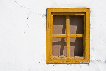 Old Yellow Window on Cracked Wall
