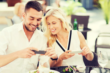 happy couple with smatphone photographing food