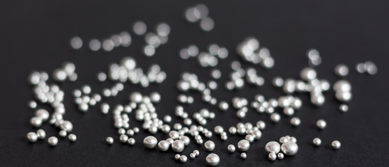 Pure silver granules on a dark background