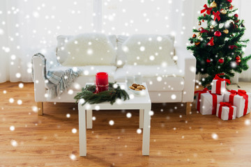 sofa, table and christmas tree with gifts at home