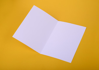 white paper bifold brochure mockup on yellow background