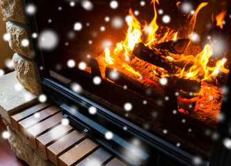 close up of burning fireplace with snow