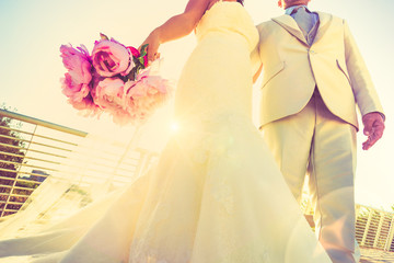 Young newlyweds with bouquet at sunset backlight - Wedding couple together after ceremony - Life...