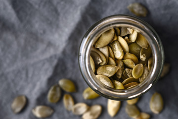 Pumpkin seeds in the glass jar cloth-up