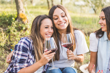 Girls drinking wine in the garden