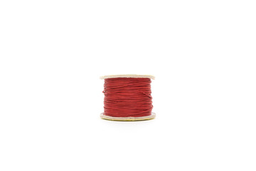 spool of red thread on white background