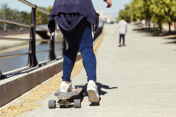 Young couple skateboarding in the street.