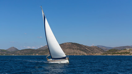 Obraz na płótnie Canvas Luxury yacht in the wind through the waves at Sea.