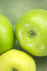 Fototapeta na wymiar Three green apples on dish