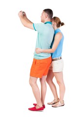 Back view of couple photographing. Tourists take pictures of the family together. Rear view people collection.  backside view of person. Isolated over white background.