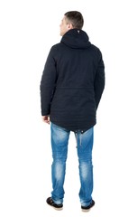 Back view of handsome man in winter jacket  looking up.   Standing young guy in parka. Rear view people collection.  backside view of person.  Isolated over white background. man in jacket looking to © ghoststone