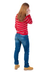 Obraz premium back view of standing young beautiful woman and using a mobile phone. girl watching. Rear view people collection. backside view of person. Isolated over white background.