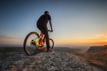 Printed kitchen splashbacks Bicycles Sunset from the top /  A man with a bike enjoys the view of sunset over an autumn forest
