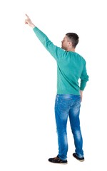 Back view of  pointing young men in jeans. Young guy  gesture. Rear view people collection.  backside view of person.  Isolated over white background. The guy in the green jacket stands sideways and