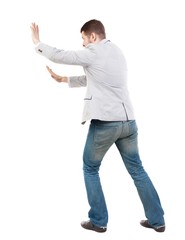 back view of business man pushes wall. Isolated over white background. Rear view people collection. backside view of person.  Bearded man ran into an obstacle.
