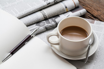 Coffee and newspapers on wooden table