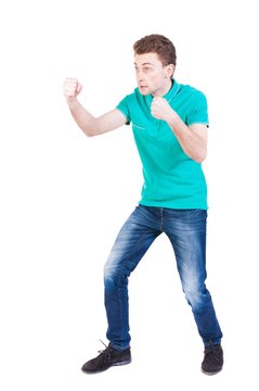 skinny guy funny fights waving his arms and legs. Isolated over white background. Funny guy clumsily boxing. Enraged man in a boxing pose.