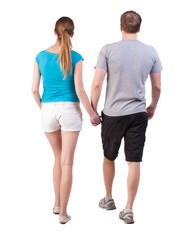 Back view of going young couple (man and woman). walking beautiful friendly girl and guy in shorts together. Rear view people collection. backside view of person.  Isolated over white background