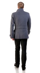 Back view of going  stylishly dressed business man in  gray coat.  walking businessman. Rear view people collection.  backside view of person.  Isolated over white background.