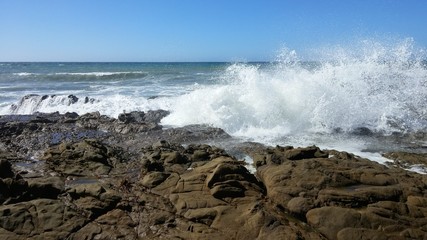 Ocean surf splashing rocks
