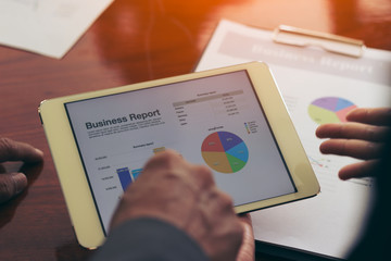 Business man and woman working with laptop and phone in office.