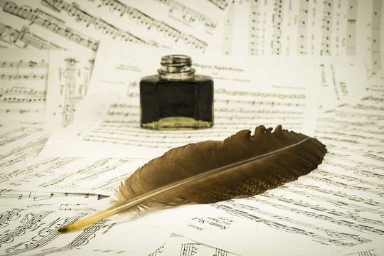 Feather and inkwell on the background notes