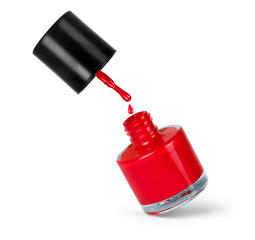 Fototapeta premium red nail polish bottle with splash isolated on white