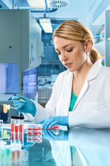 Young energetic female tech or scientist works in laboratory
