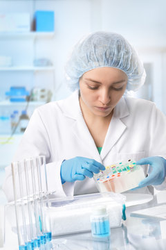 Young European female scientist or tech works in laboratory