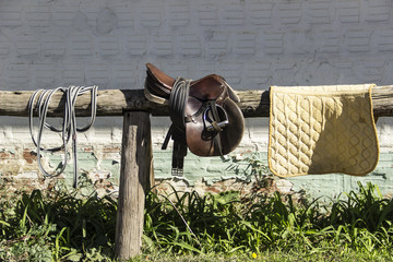 Saddle and saddlecloth on a timber frame 