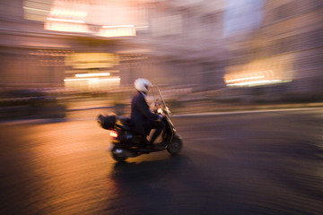 Panning shot of typical Roman scooter