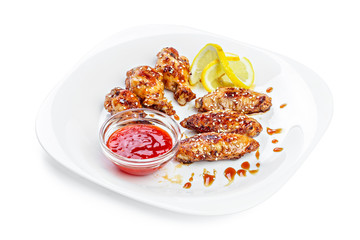 chicken wings on plate with sauce