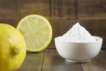 Baking soda and lemon on wooden table