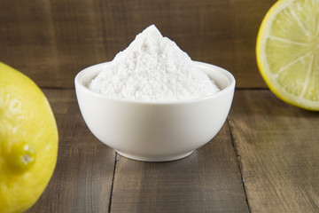 Baking soda and lemon on wooden table