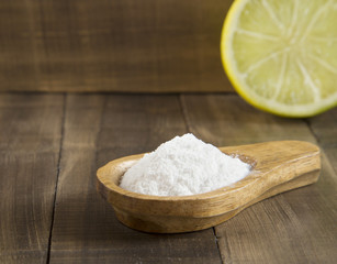 Baking soda and lemon on wooden table