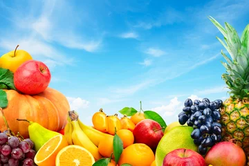 Türaufkleber Large collection of fruits and vegetables on a blue sky background © Serghei V
