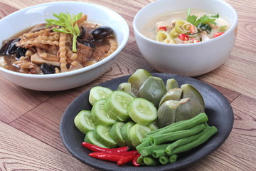 Mixed vegetable is side dish of spicy sauce in organic Asian cuisine as streamed eggplant,sliced cucumber,  lentils and red chili. Selective focus.